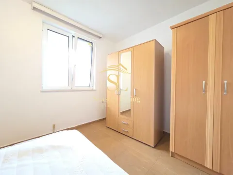 Furnished bedroom with wardrobes and a window. - image 11