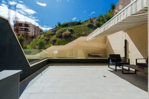 Spacious terrace with seating furniture and an awning. - image 7