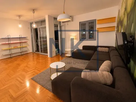Living room with a sectional sofa, parquet flooring, and access to the terrace. - image 3