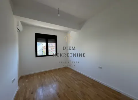 Empty room with parquet flooring and white walls. - image 5