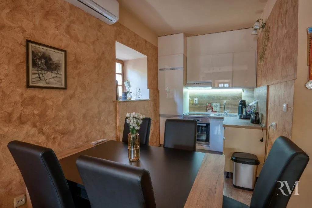 Dining area with a table and chairs overlooking the kitchen.
