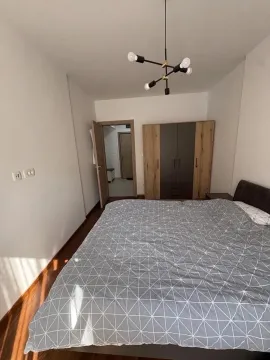 Furnished bedroom with a double bed and wardrobe. - image 11