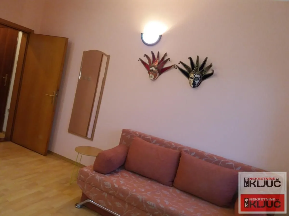 Living room with a sofa and decorative masks on the wall.