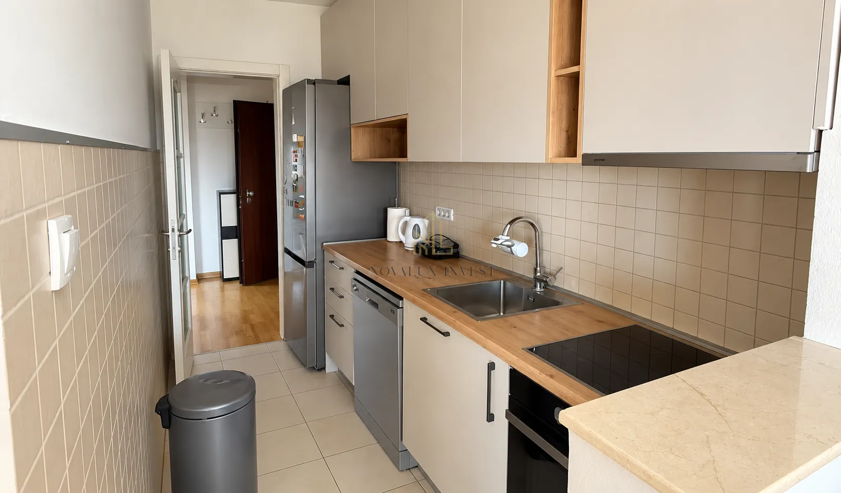 Small kitchen with built-in units and appliances.