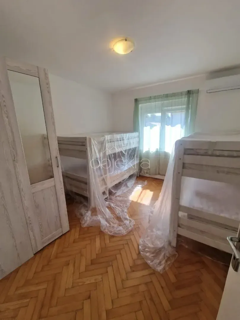 Bedroom with bunk beds covered in protective foil.