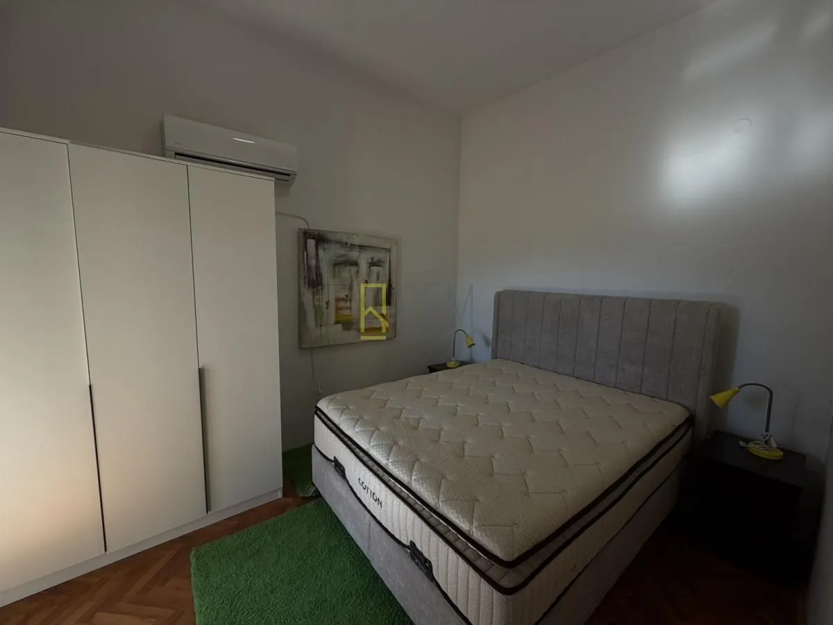 Bedroom with a double bed, wardrobe, and air conditioning.