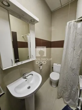Bathroom with a sink, mirror, and toilet. - image 5