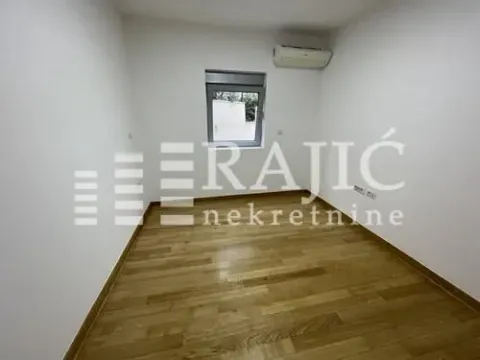 Empty room with wooden flooring and white walls. - image 3