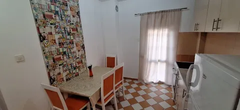 Smaller kitchen with a dining table and chairs. - image 6