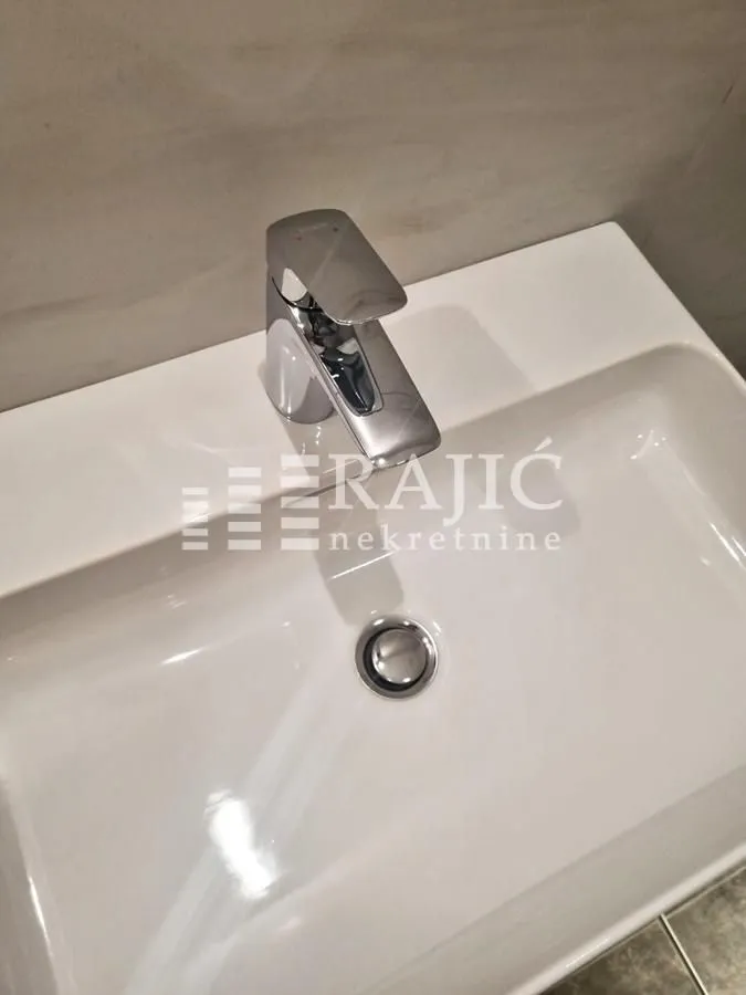 Modern washbasin with a faucet in the bathroom.