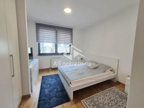 Furnished bedroom with a double bed, wardrobe, and a window. - image 8