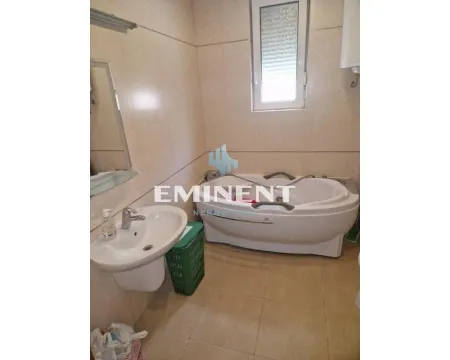 Bathroom equipped with a bathtub, washbasin, and tiled walls. - image 19