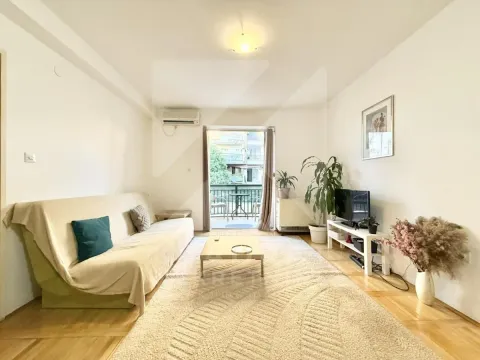 Living room with a sofa, TV, and access to the terrace. - image 2
