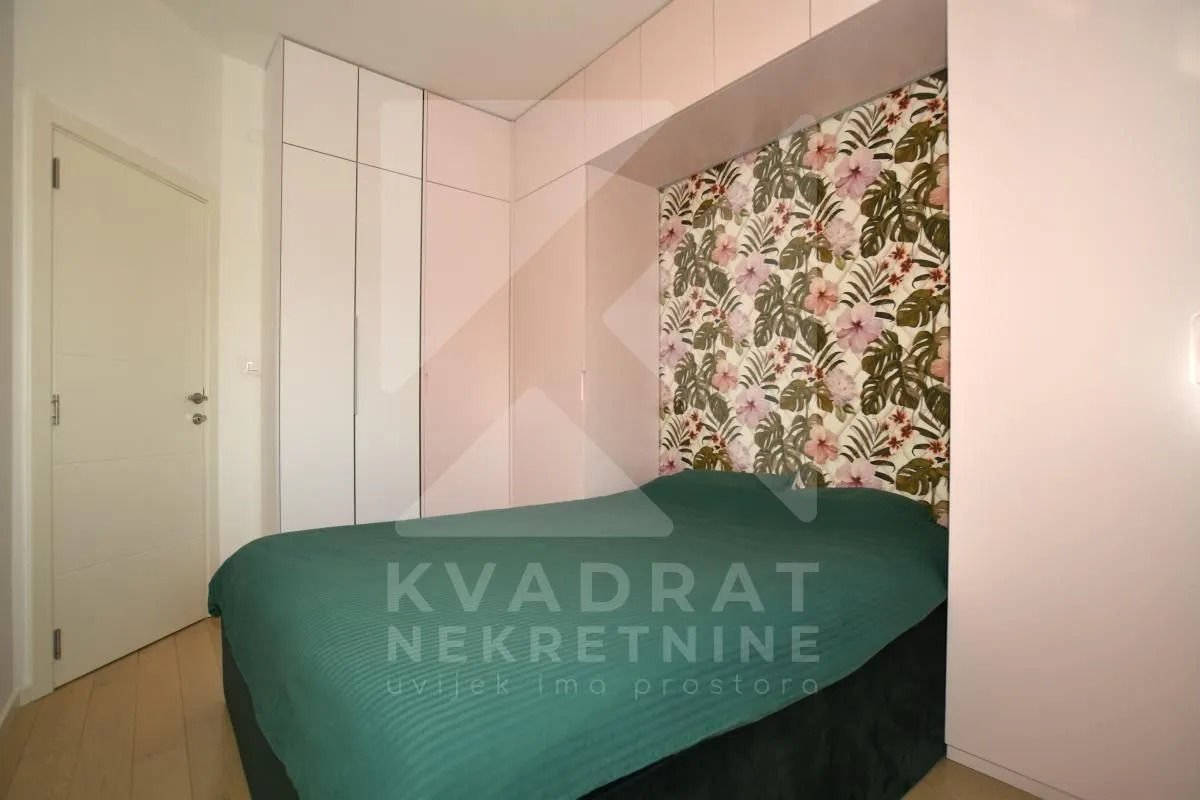 Furnished bedroom with a double bed and built-in wardrobes.