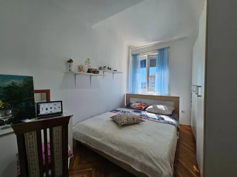Furnished bedroom with a double bed, wardrobe, and window. - image 7