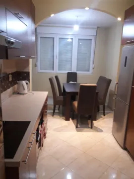 Kitchen with a dining table and chairs. - image 4