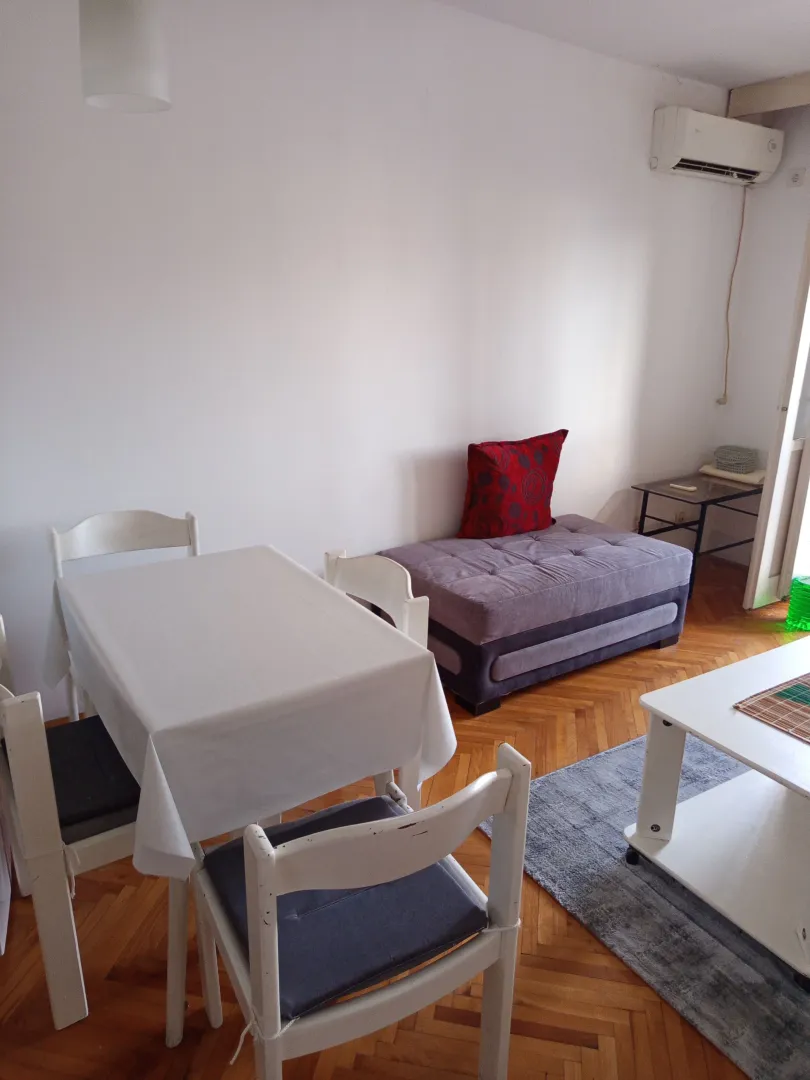 Living room with a dining table and sofa.