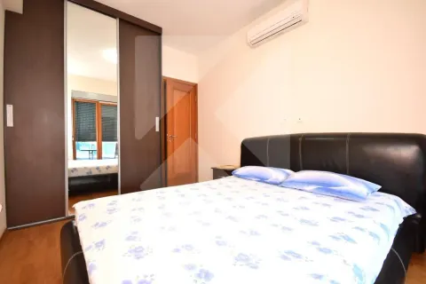 Bedroom with a double bed, large wardrobe, and air conditioning. - image 6