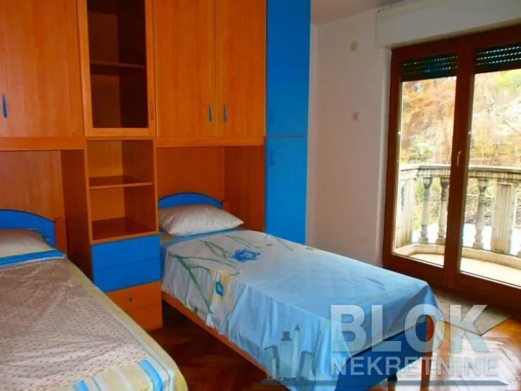 Children's bedroom with two beds and fitted wardrobes.