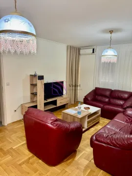 Living room with a sofa set, TV cabinet, and parquet flooring. - image 2