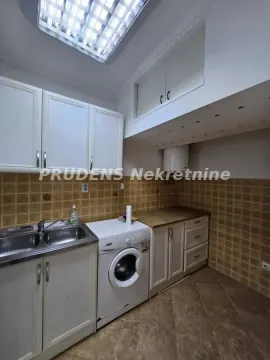 Small kitchen with white cabinets and a sink. - image 5