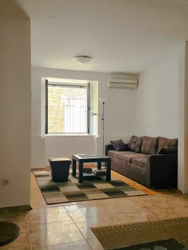 Living room with a sofa set, coffee table, and a window. - image 2