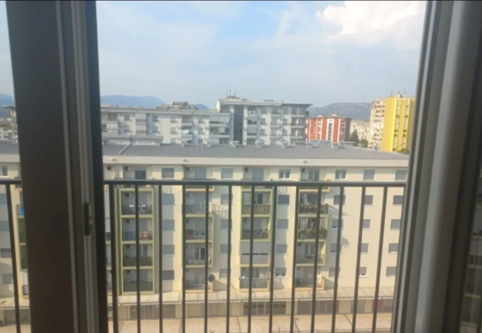 View from the apartment overlooking surrounding residential buildings and the city neighborhood.