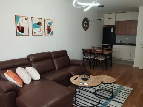 Living room with a sofa connected to the dining area and kitchen. - image 3