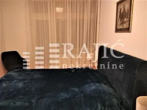 Comfortable bedroom with a large double bed and dark upholstery. - image 10