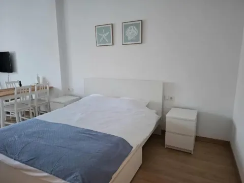 Bright bedroom with a double bed and nightstands. - image 3