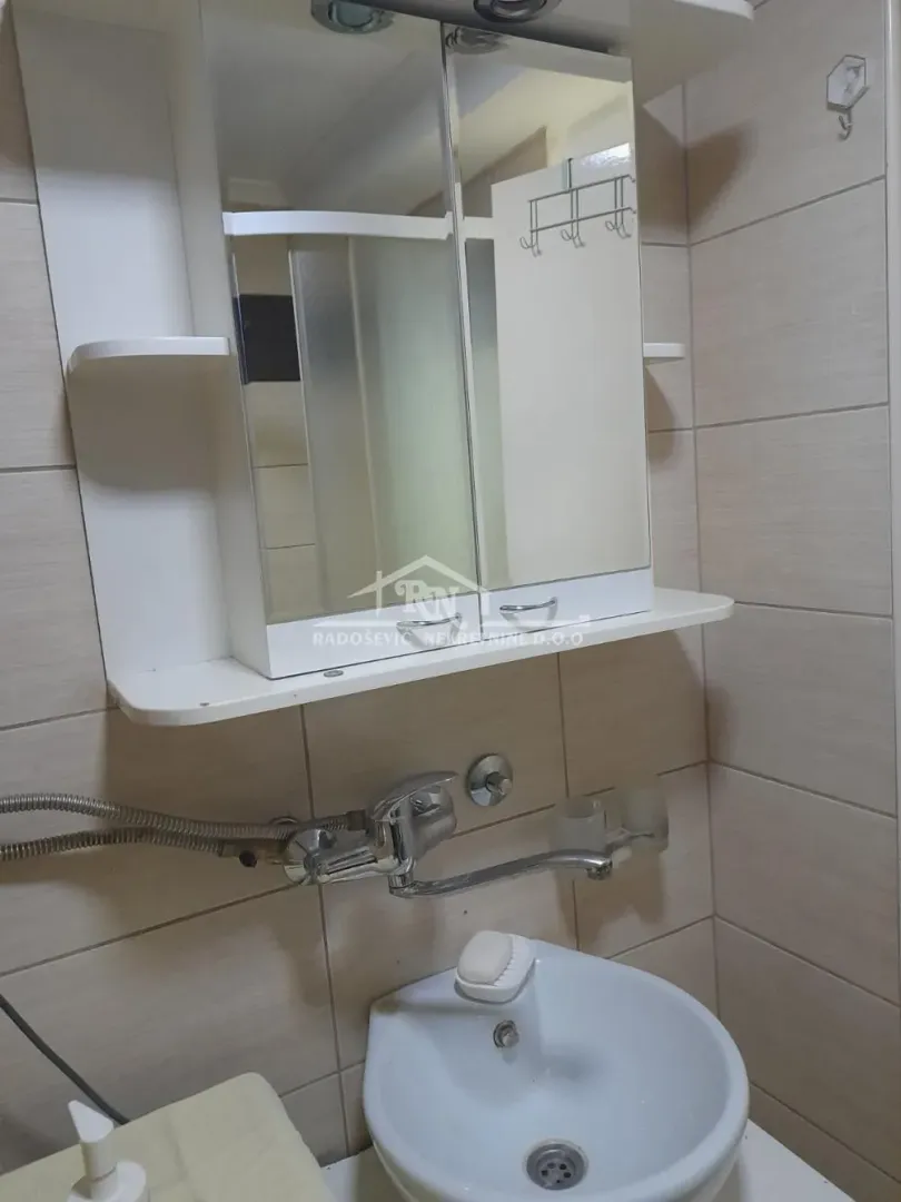 Small bathroom with a sink and mirror cabinet.