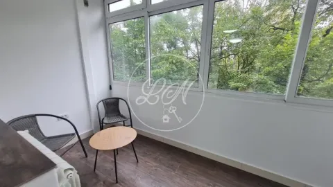 Glazed terrace with seating furniture and a view of greenery. - image 15
