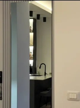 View of a modern kitchen interior through a doorway. - image 7