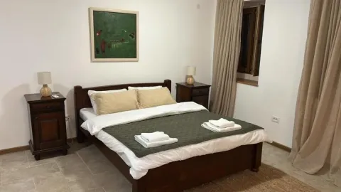 Bedroom with a double bed, bedside tables and a painting on the wall. - image 2