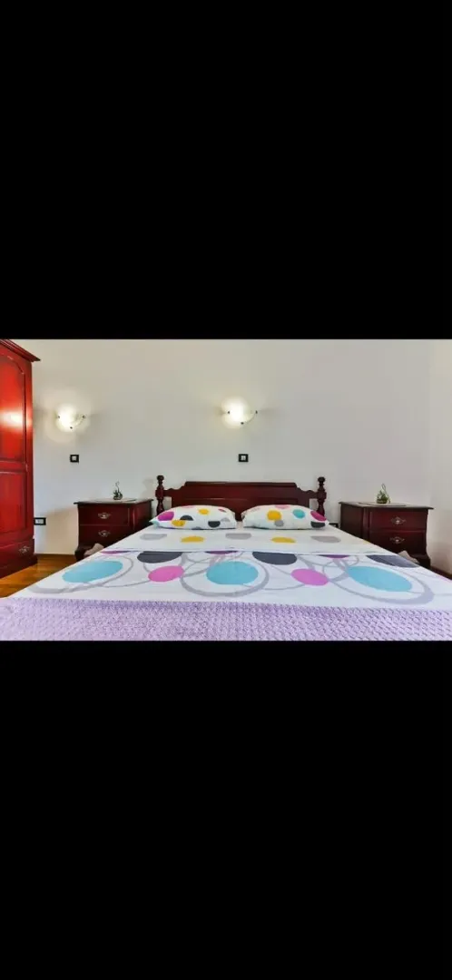 Furnished bedroom with a double bed and nightstands.