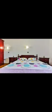 Furnished bedroom with a double bed and nightstands. - image 6