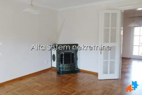 Living room with a fireplace and parquet flooring. - image 5