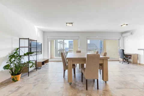 Spacious living room with a dining table and access to the terrace. - image 6