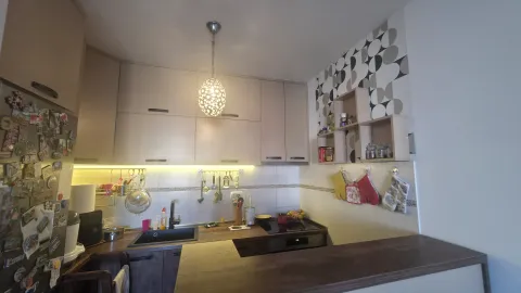 Modern kitchen with wall cabinets, countertops, and built-in lighting. - image 4