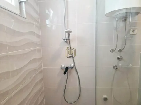 Pogled na tuš kabinu sa slavinom i keramičkim pločicama u kupatilu. - image 9