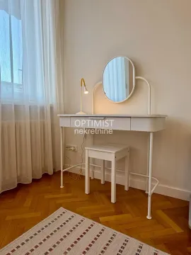 White dressing table with a mirror and a stool in the bedroom. - image 17