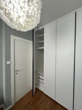 Modern built-in wardrobe with open shelves and drawers. - image 8