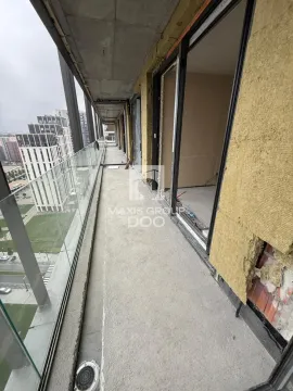 Long unfurnished balcony under construction with glass railing and city view. - image 10