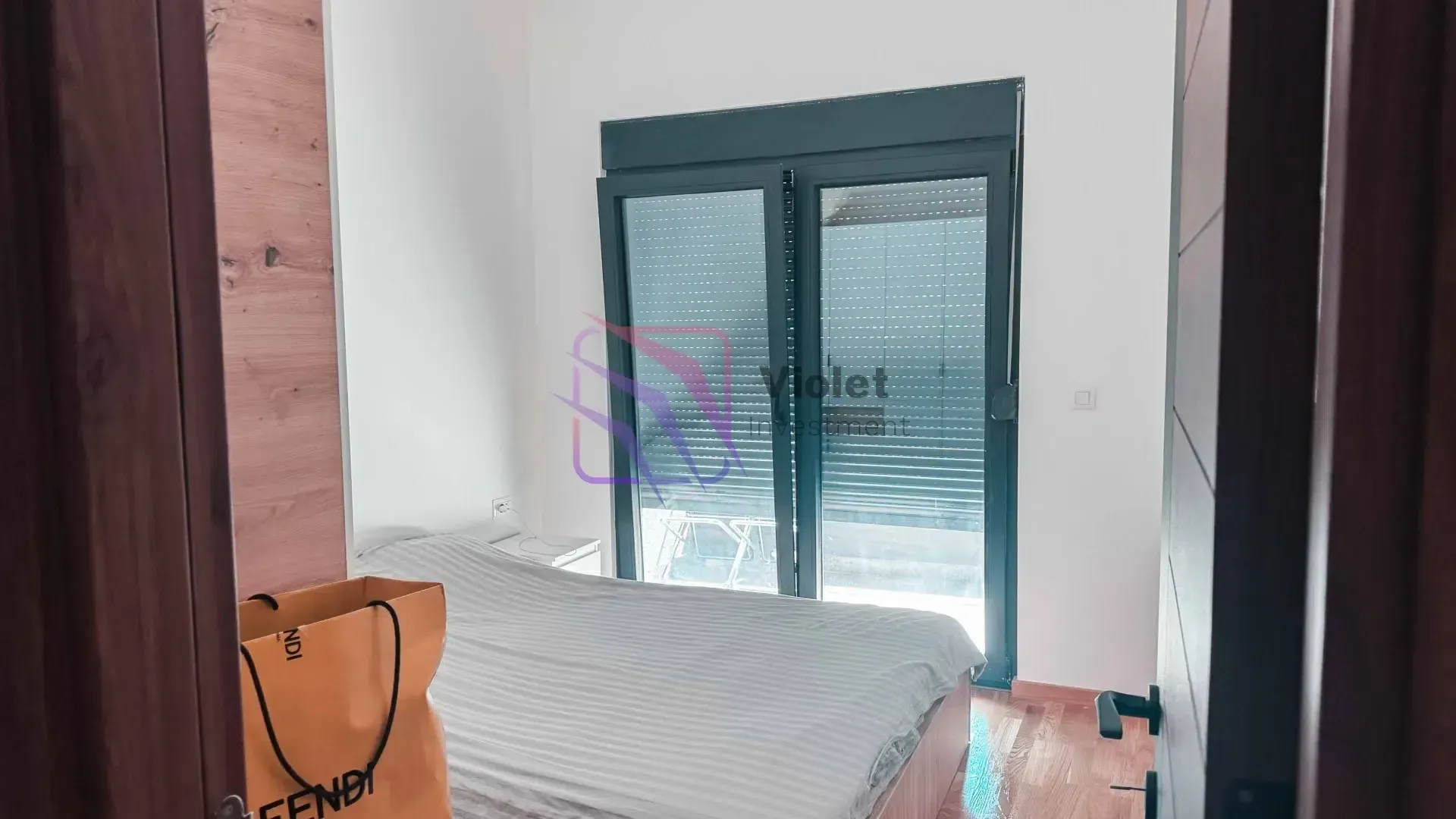 Smaller bedroom with a double bed and access to the terrace.
