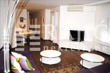 Living room with a sofa set and dining area in the background. - image 4