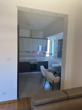 View from the living room towards the kitchen with a dining area. - image 7
