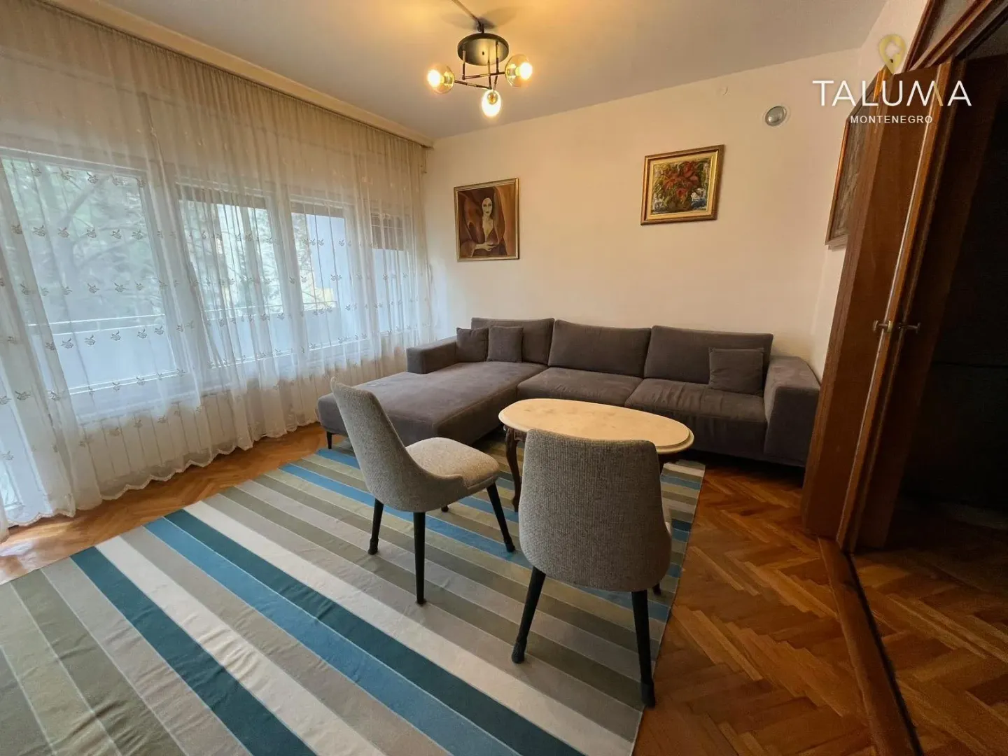 Living room with a corner sofa, coffee table, and rug.