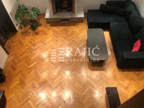 Living room with a sofa set, fireplace and parquet flooring. - image 3