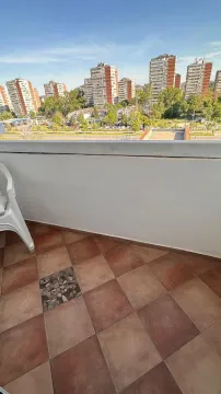 Small tiled balcony with a city view. - image 16