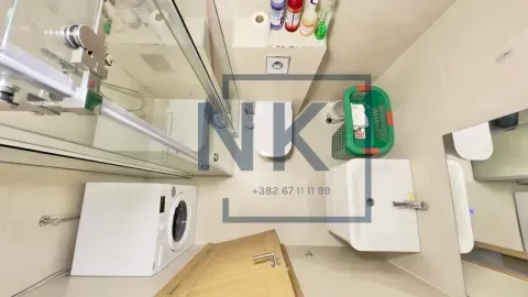 Top-down view of a modern bathroom with a glass shower enclosure and washing machine. - image 11